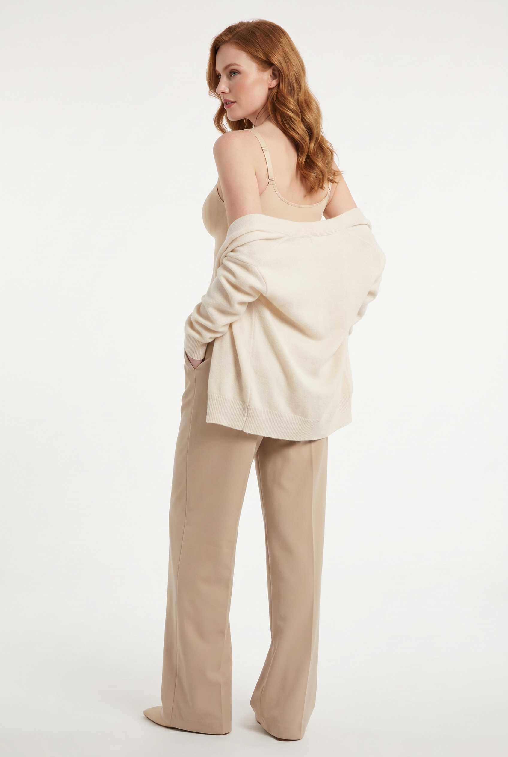 Model wearing cami top with cardigan, back angle
