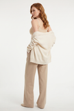 Model wearing cami top with cardigan, back angle